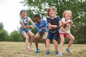 Kids between the ages of 1-4 playing tug of war